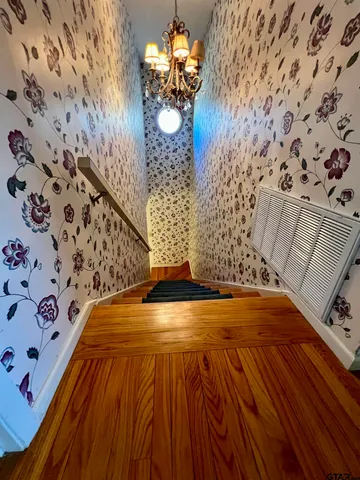 a view of a room with wooden floor