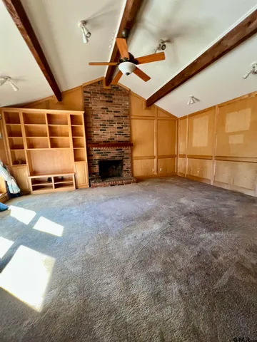 a view of an empty room with a fireplace