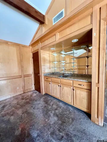 a kitchen with granite countertop white cabinets and stainless steel appliances