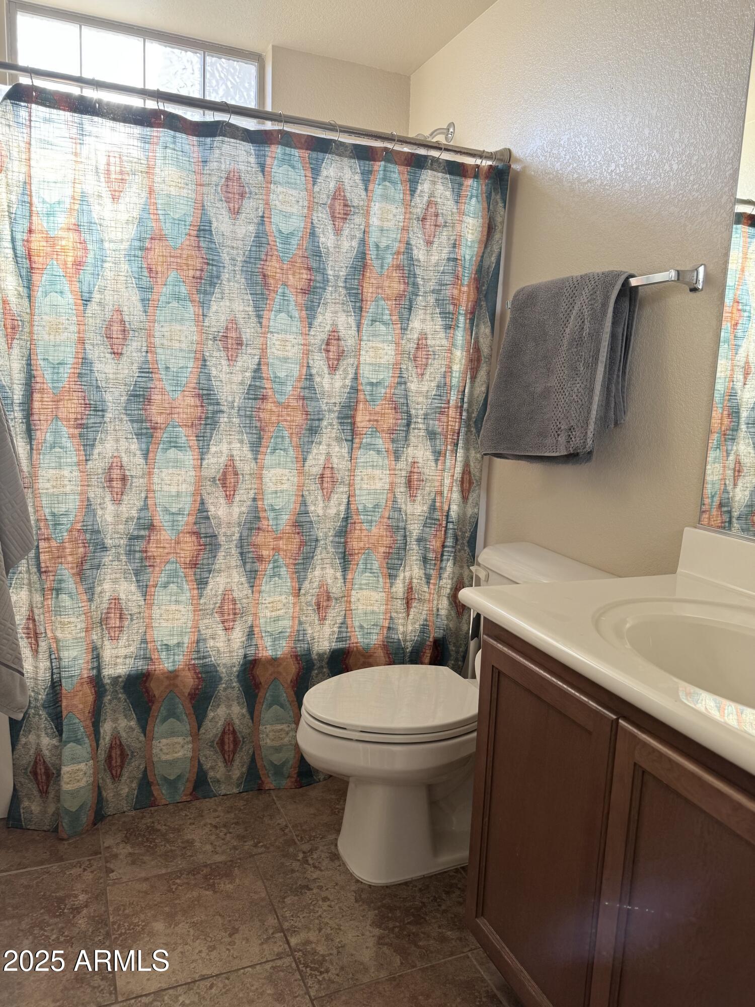 2150 West Alameda Road, Unit 1032 Phoenix, AZ 85085 - Photo 18 of 39 a bathroom with a sink a toilet and shower curtain
