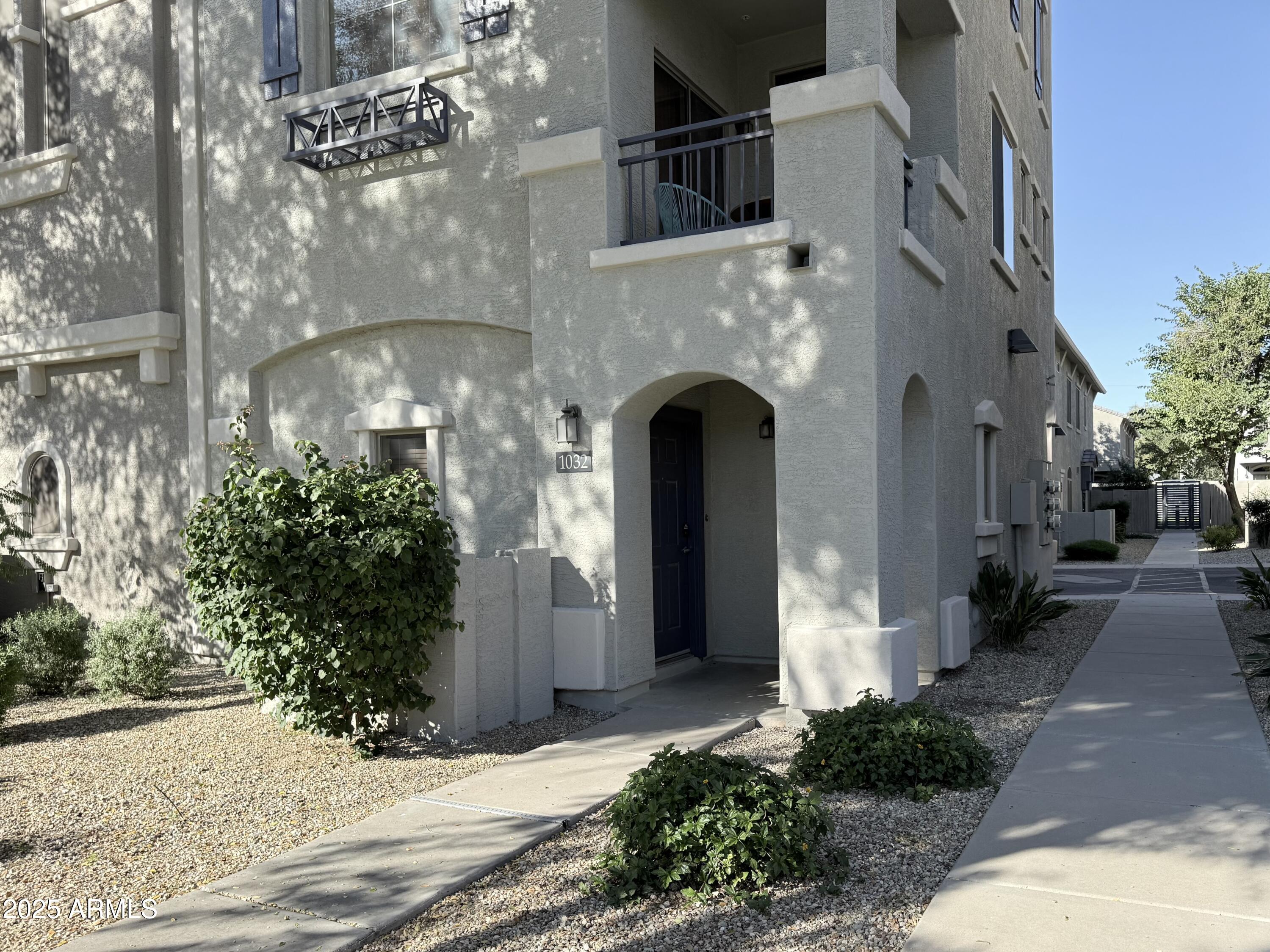 2150 West Alameda Road, Unit 1032 Phoenix, AZ 85085 - Photo 23 of 39 a front view of a house with plants