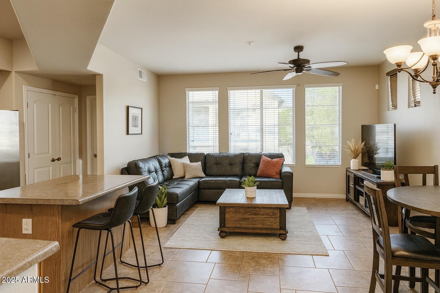 2150 West Alameda Road, Unit 1032 Phoenix, AZ 85085 - Photo 4 of 39 a living room with furniture and a flat screen tv