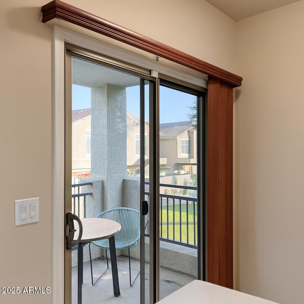 2150 West Alameda Road, Unit 1032 Phoenix, AZ 85085 - Photo 6 of 39 a view of a hallway with wooden floor and a dining table