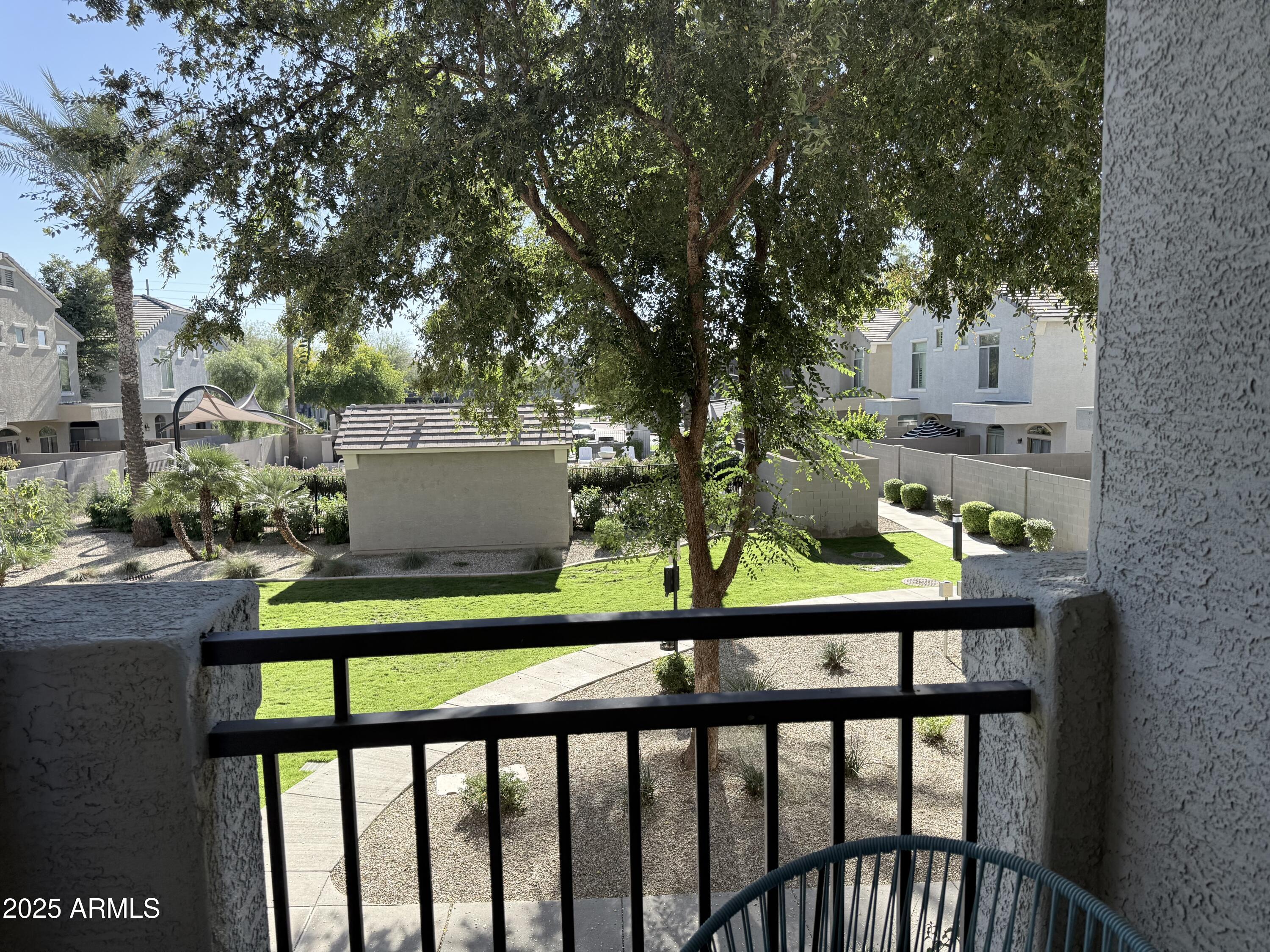 2150 West Alameda Road, Unit 1032 Phoenix, AZ 85085 - Photo 7 of 39 a view of a porch with furniture and trees