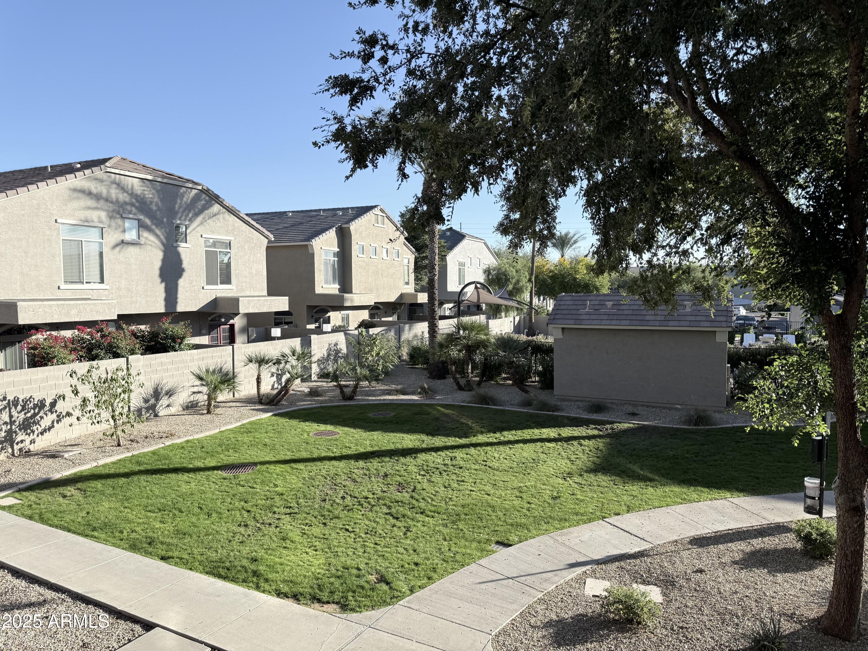 2150 West Alameda Road, Unit 1032 Phoenix, AZ 85085 - Photo 9 of 39 a front view of a house with a yard