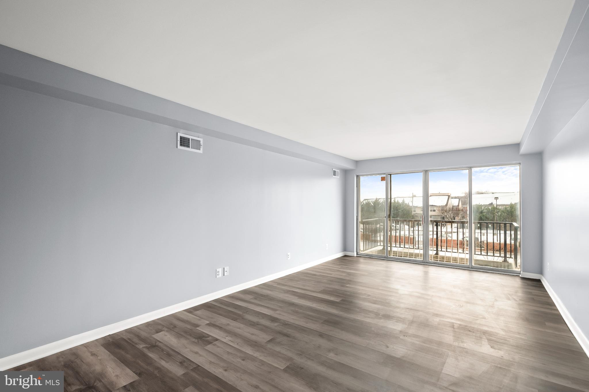 3601 Clarks Lane, Unit 322 Baltimore, MD 21215 - Photo 29 of 38 Living room (without virtual staging) and balcony.