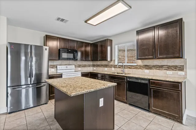 a view of kitchen and hall with wooden floor
