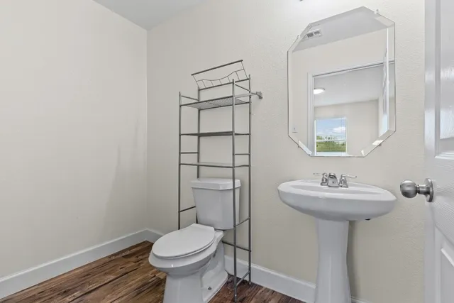 a view of an empty room and wooden floor