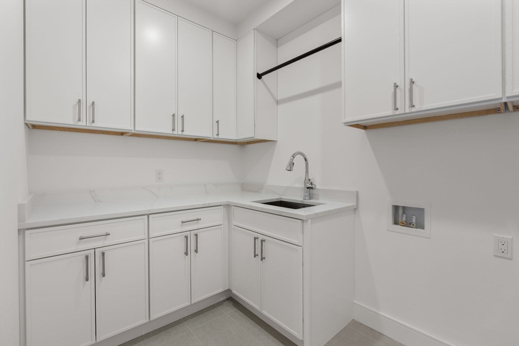 470 Quinobequin Road Newton, MA 02468 - Photo 29 of 37 a kitchen with white cabinets and white appliances