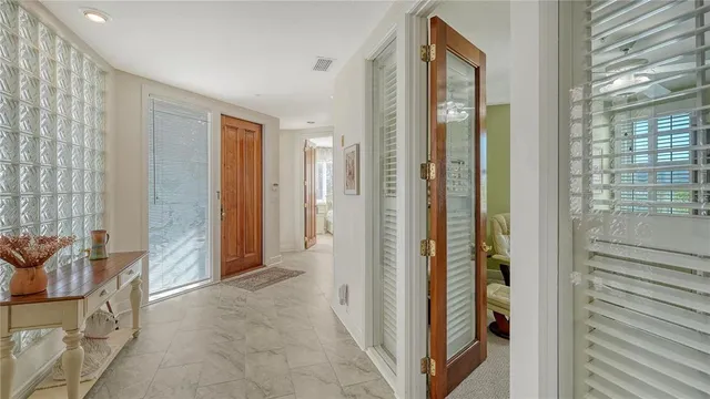 a view of a hallway with wooden shelves
