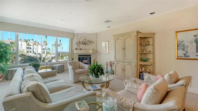 a living room with furniture fireplace and a large window