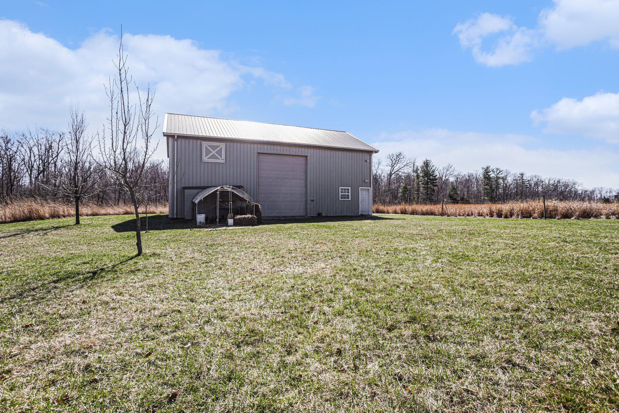 1855 Spring Valley Road London, OH 43140 - Photo 40 of 54 An overhead door leading to the grass.