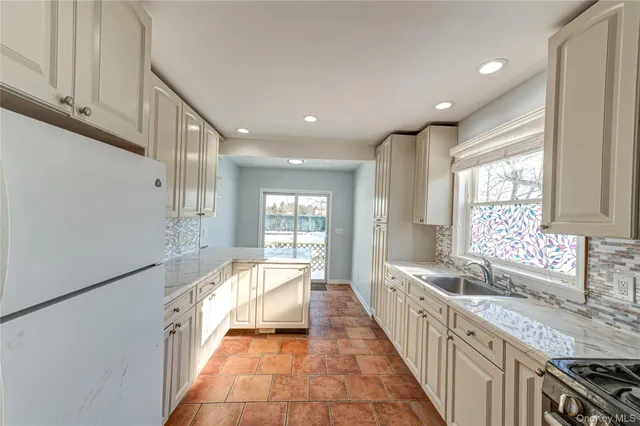 a view of a kitchen with a sink and windows