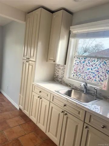 a kitchen with granite countertop a sink and a refrigerator