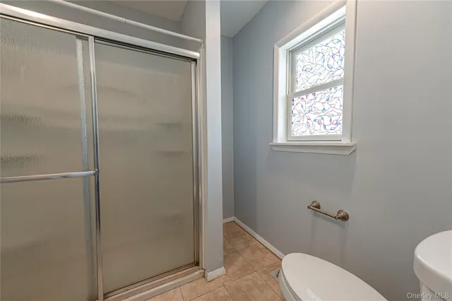 a bathroom with a toilet and a shower