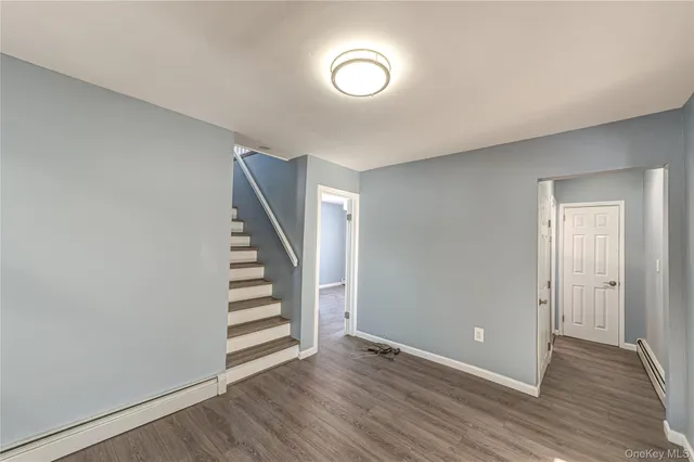 a view of room with stairs and wooden floor