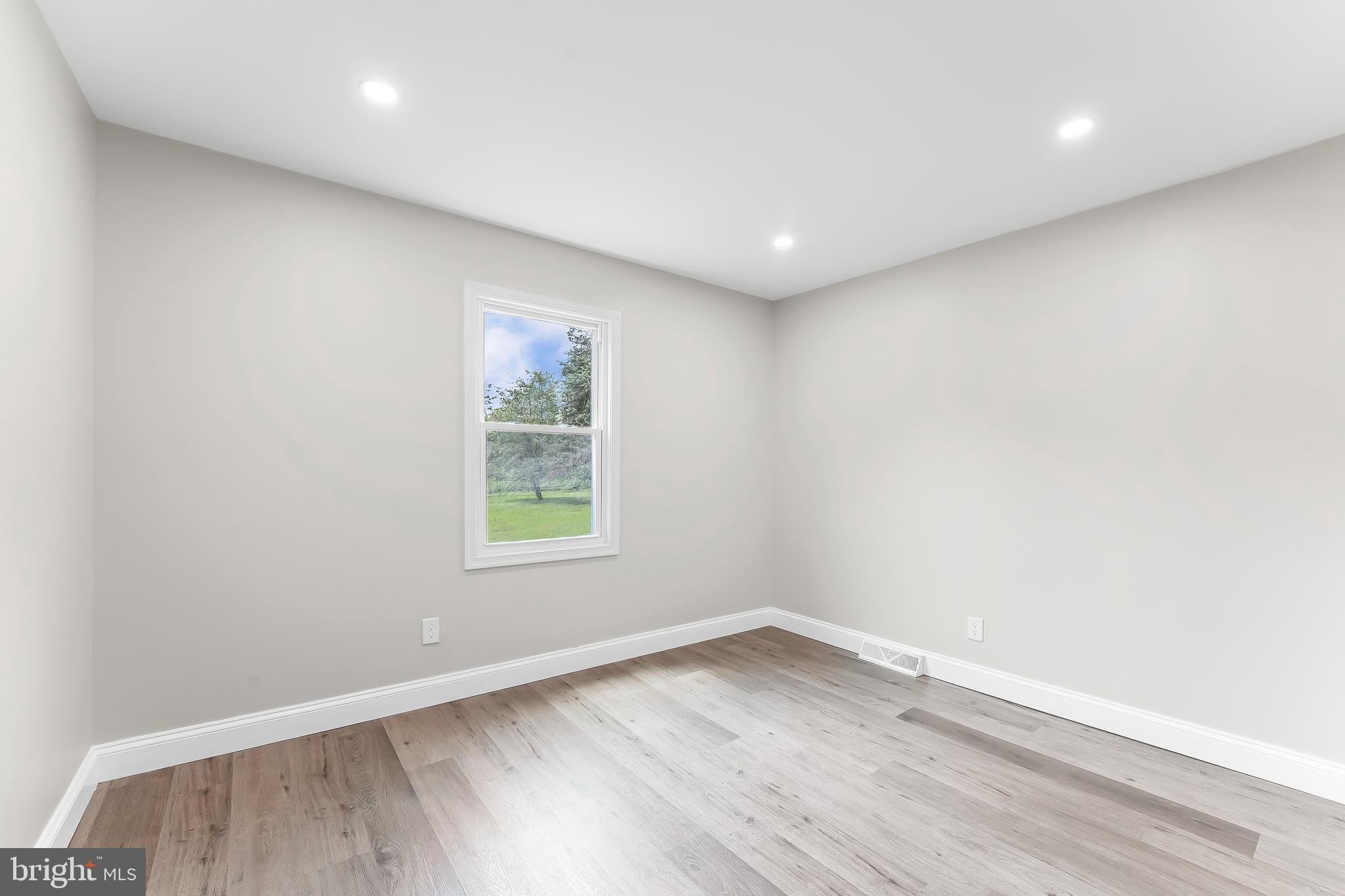 250 Red Pump Road Nottingham, PA 19362 - Photo 21 of 29 an empty room with wooden floor and window