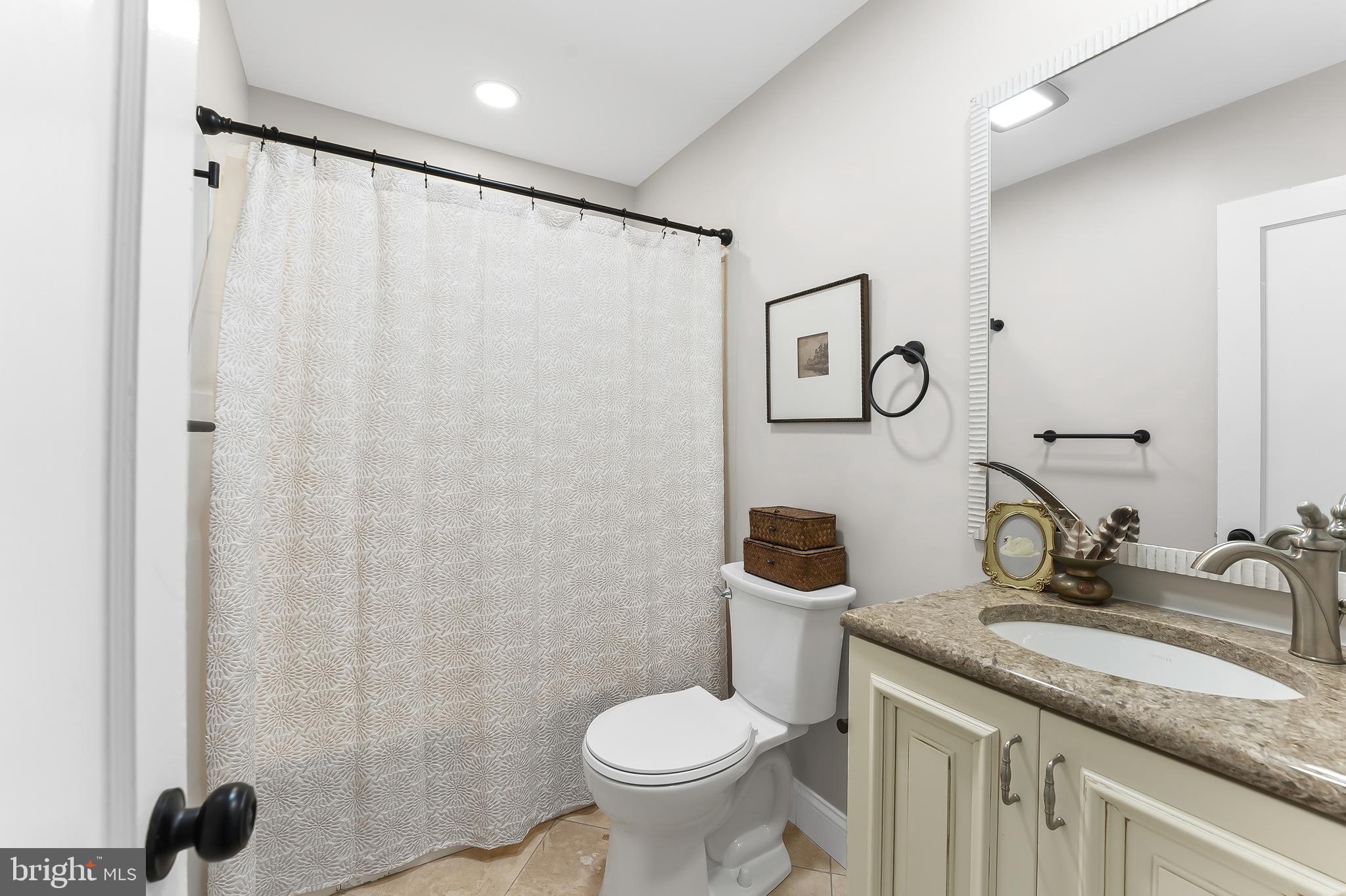 250 Red Pump Road Nottingham, PA 19362 - Photo 23 of 29 a bathroom with a granite countertop sink toilet and a mirror