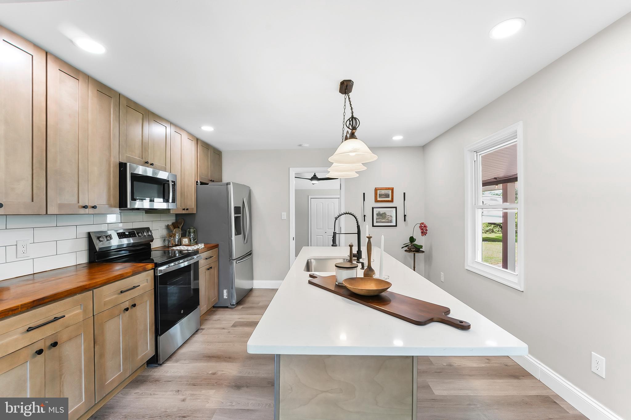 250 Red Pump Road Nottingham, PA 19362 - Photo 6 of 29 a kitchen with kitchen island granite countertop a sink stainless steel appliances and cabinets
