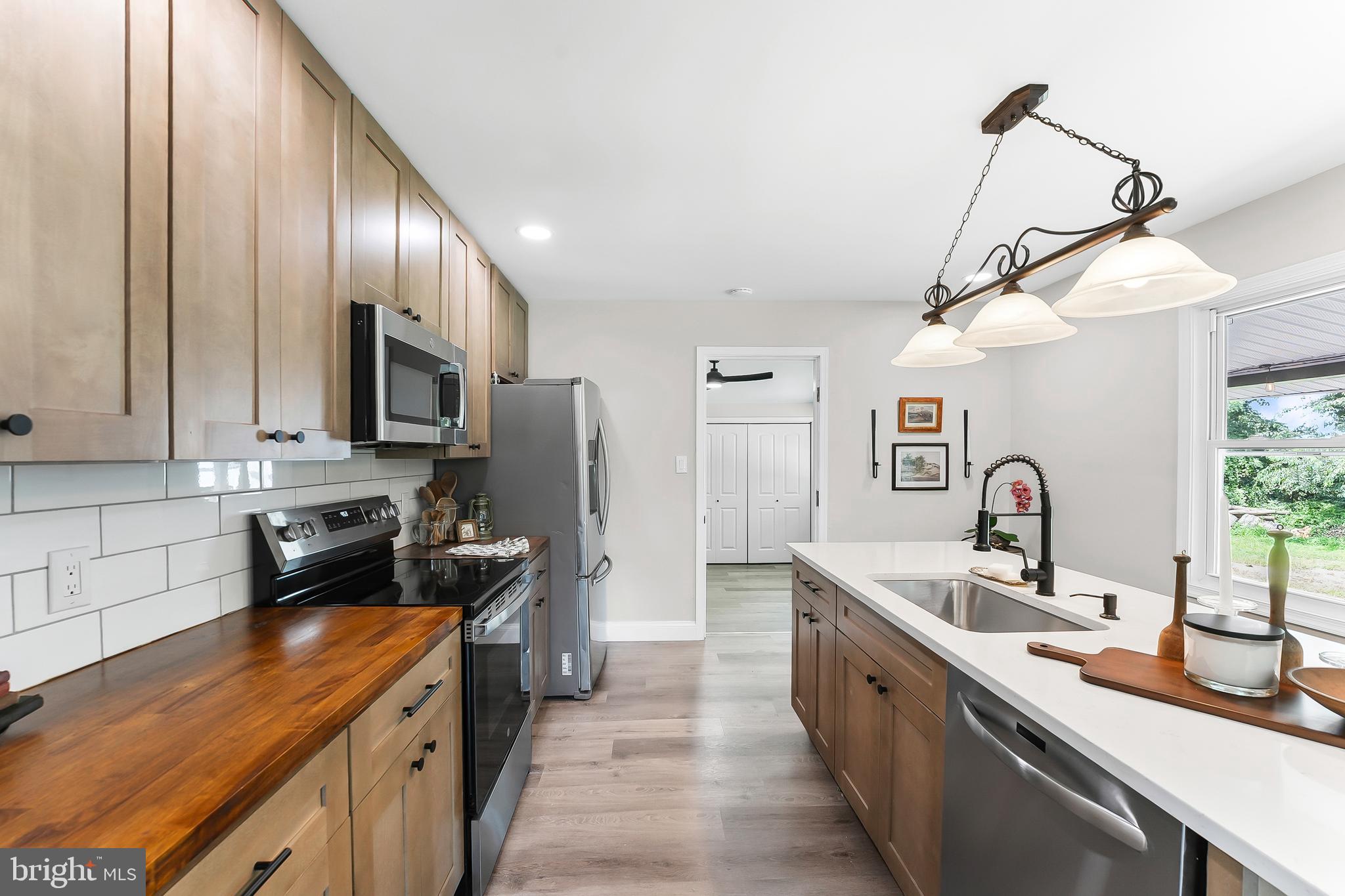 250 Red Pump Road Nottingham, PA 19362 - Photo 9 of 29 a large kitchen with stainless steel appliances a sink a stove and a refrigerator