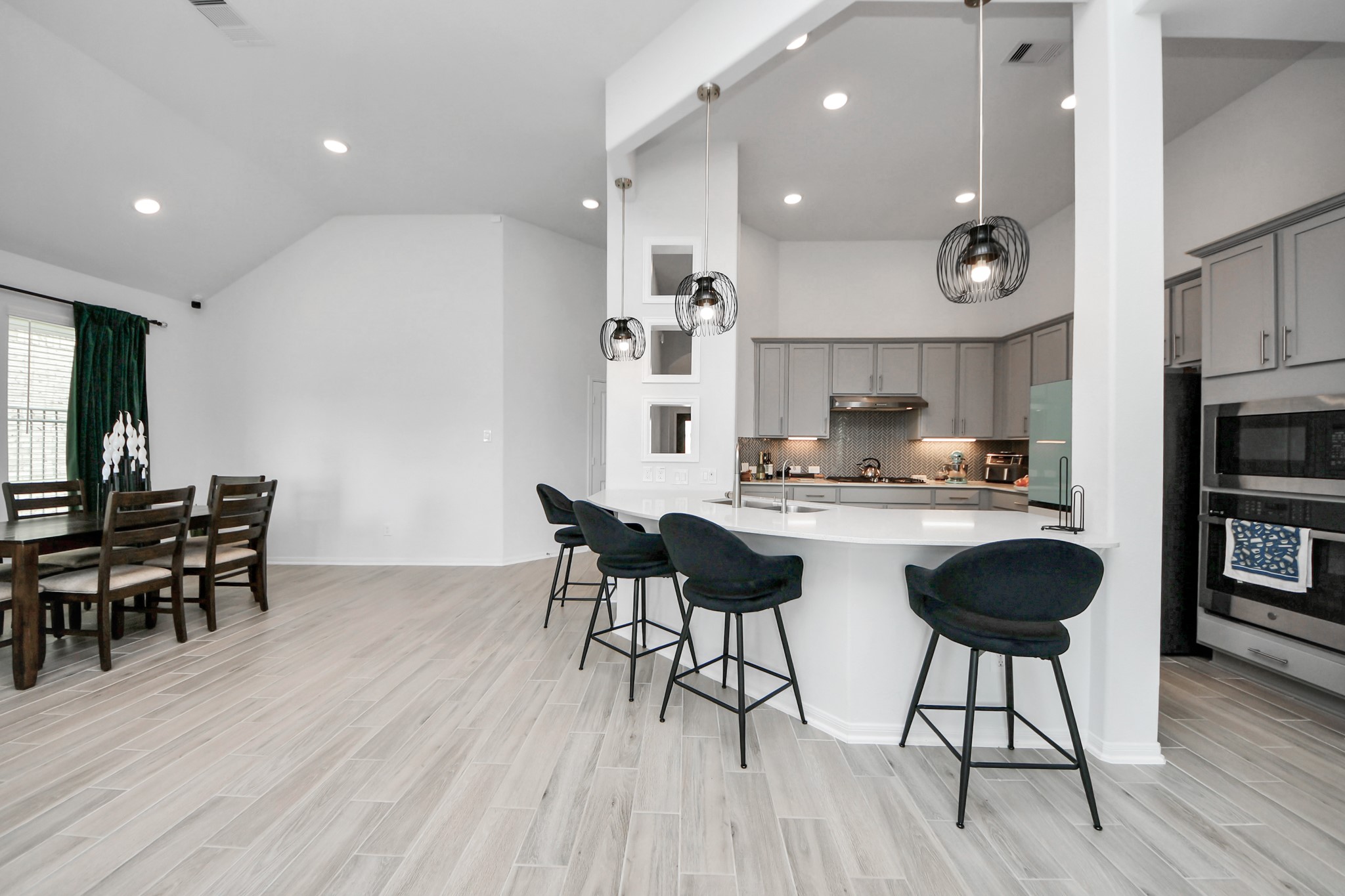 1614 Sequoia Run Drive Rosharon, TX 77583 - Photo 16 of 45 a kitchen with stainless steel appliances granite countertop a stove a sink a dining table and chairs with wooden floor