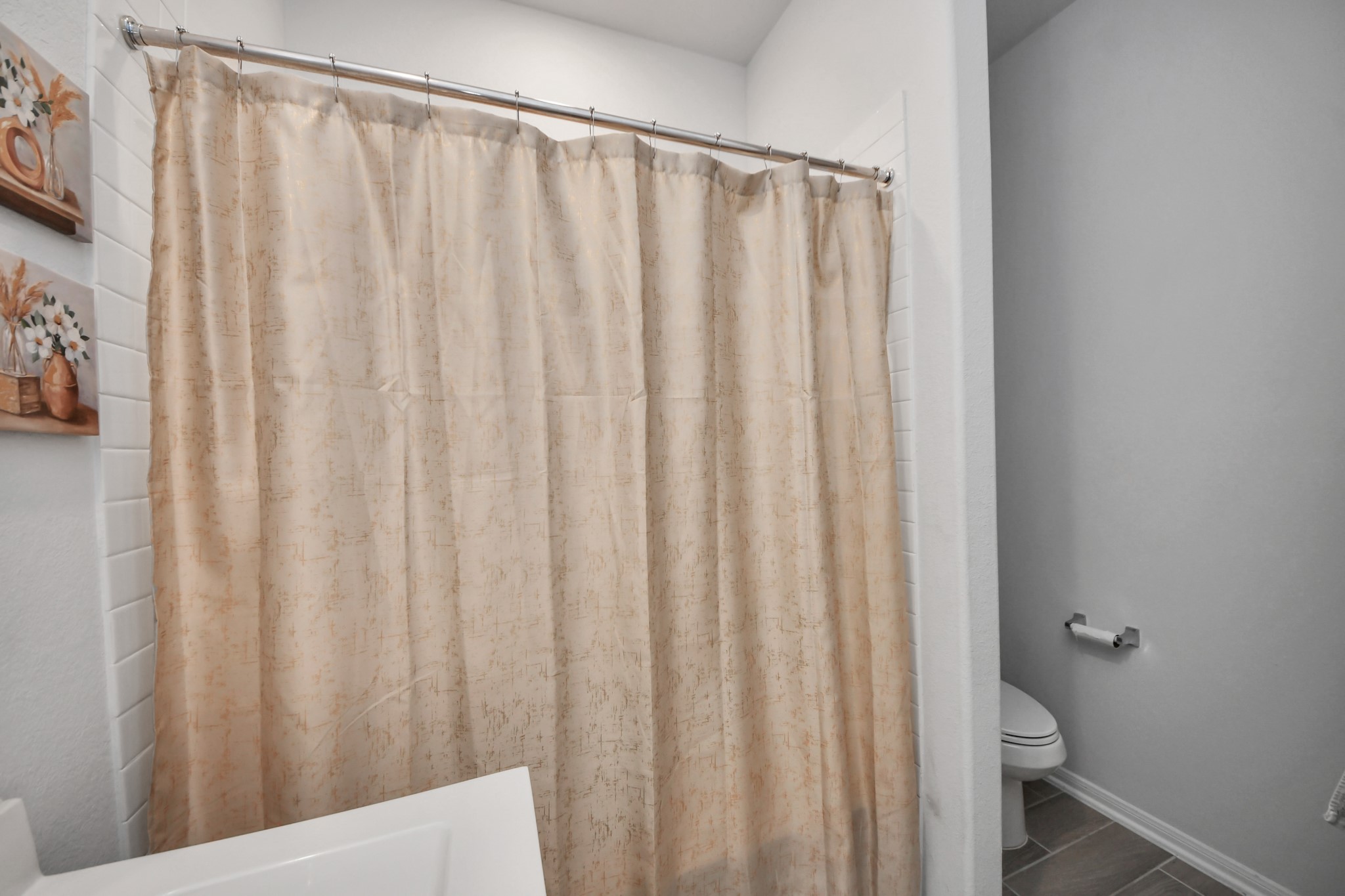 1614 Sequoia Run Drive Rosharon, TX 77583 - Photo 36 of 45 a view of a bathroom with a shower curtain and a wooden door