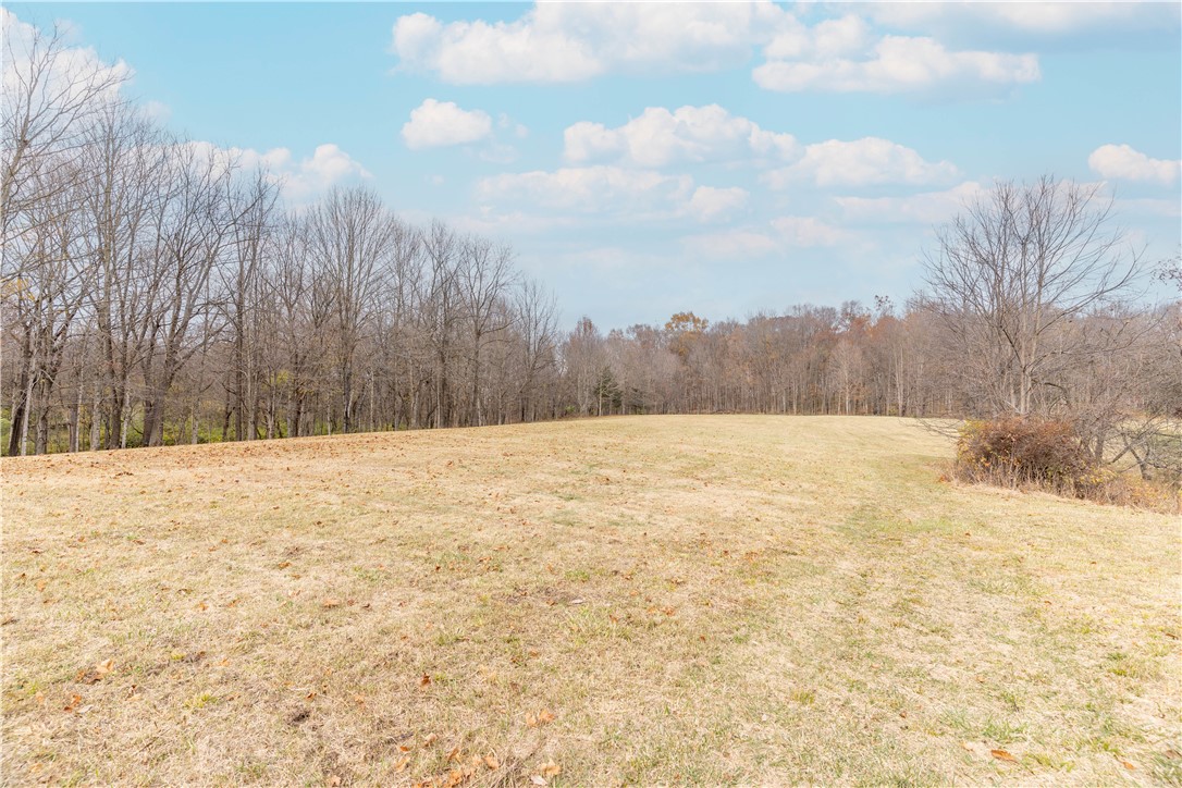 18333 Lefevre Number 2 Road Sidney, OH 45365 - Photo 22 of 25 Expansive natural landscape with open fields and a distant tree line under a clear sky.