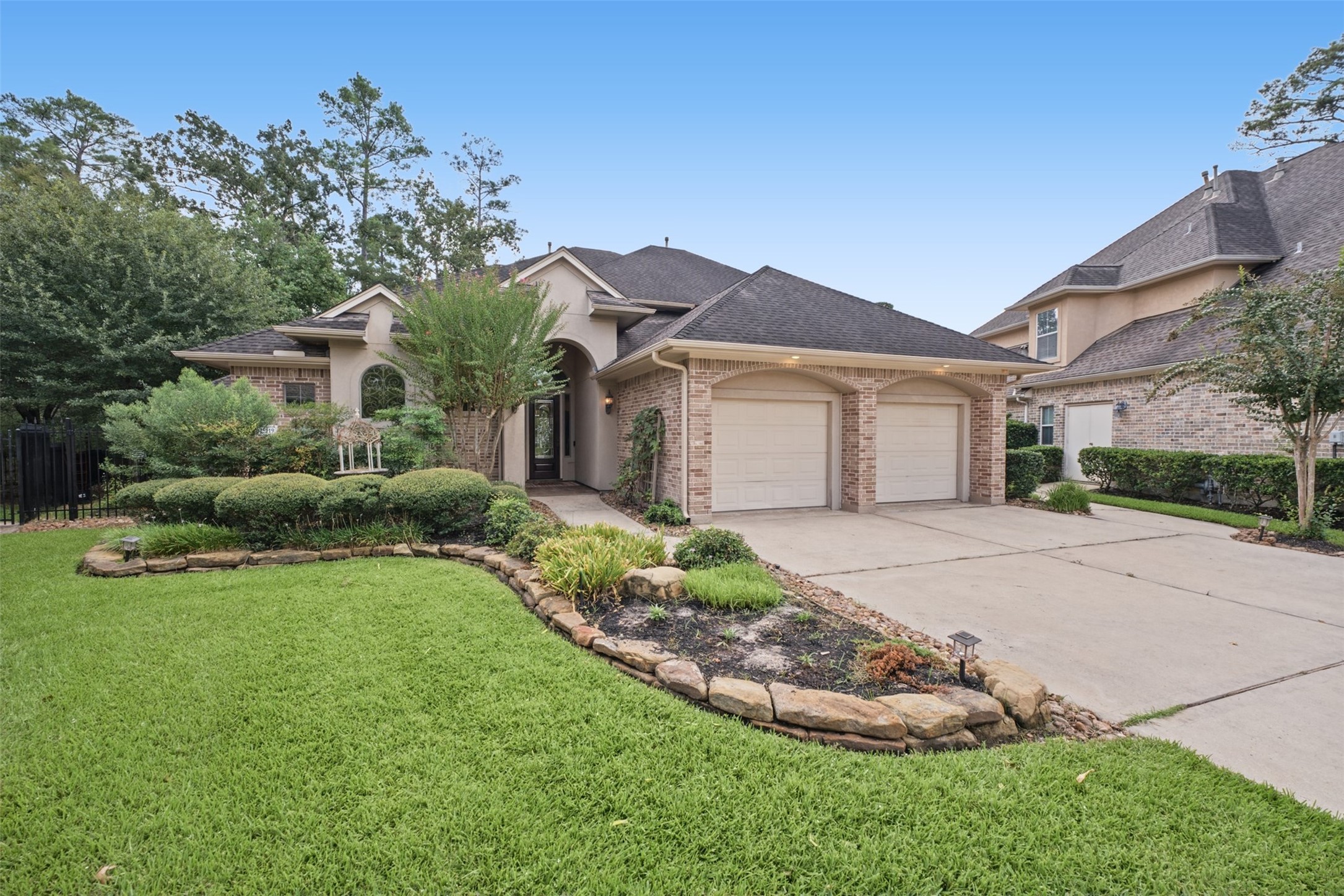25119 Arcane Court Spring, TX 77389 - Photo 5 of 50 An Unforgettable First Impression! Sitting on one of the larger lots in the community, this stately custom residence commands attention with exceptional curb appeal and extensive landscaping enhancements, including back yard lighting that beautifully showcases the property after dark. The expansive over-sized garage offers workshop space and a 3rd side bay for a golf cart.