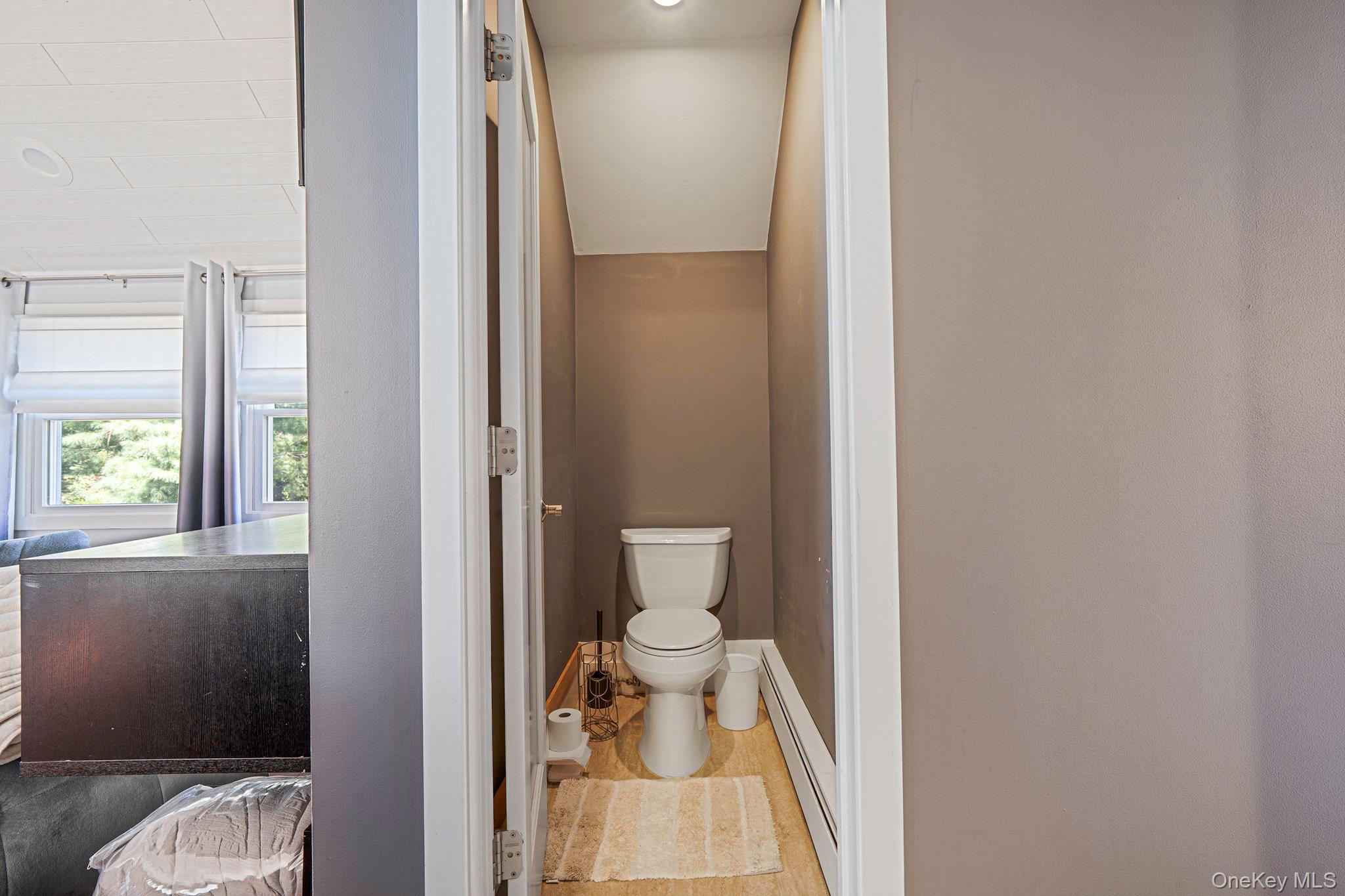 183 Old Country Road Speonk, NY 11972 - Photo 18 of 48 Bathroom with toilet and a baseboard radiator