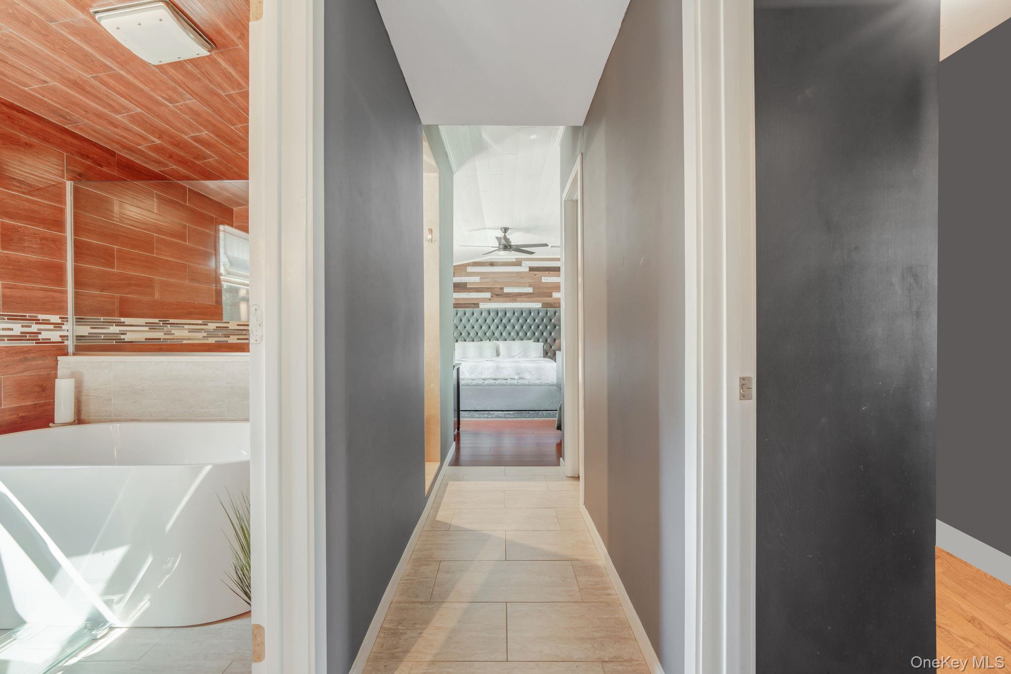 183 Old Country Road Speonk, NY 11972 - Photo 20 of 48 Hallway featuring light tile patterned flooring and baseboards