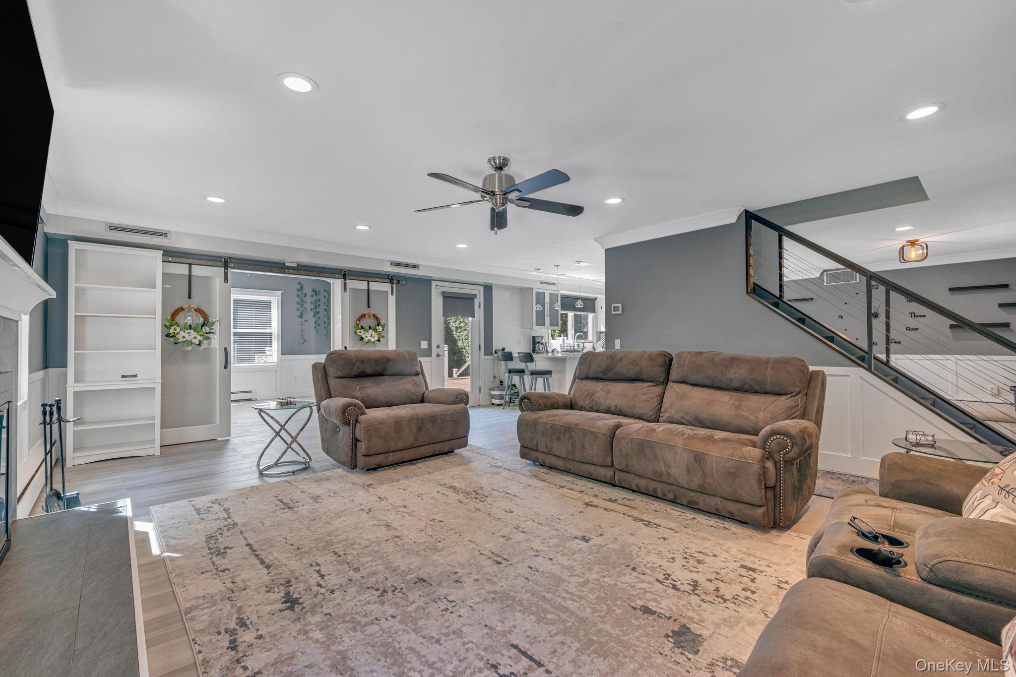 183 Old Country Road Speonk, NY 11972 - Photo 22 of 48 Living area featuring crown molding, recessed lighting, stairs, light wood-style floors, and a ceiling fan
