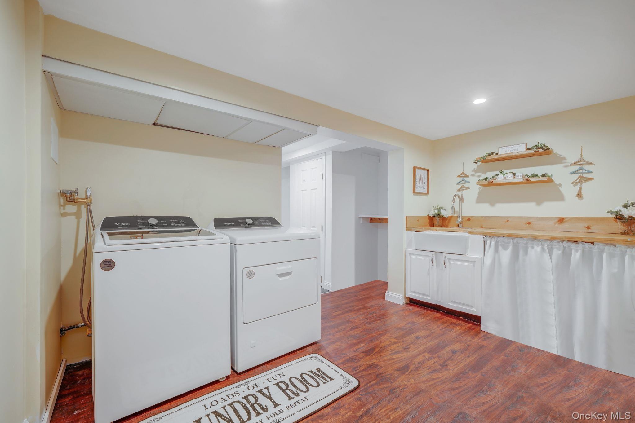 183 Old Country Road Speonk, NY 11972 - Photo 36 of 48 Washroom with dark wood finished floors, washing machine and clothes dryer, and recessed lighting