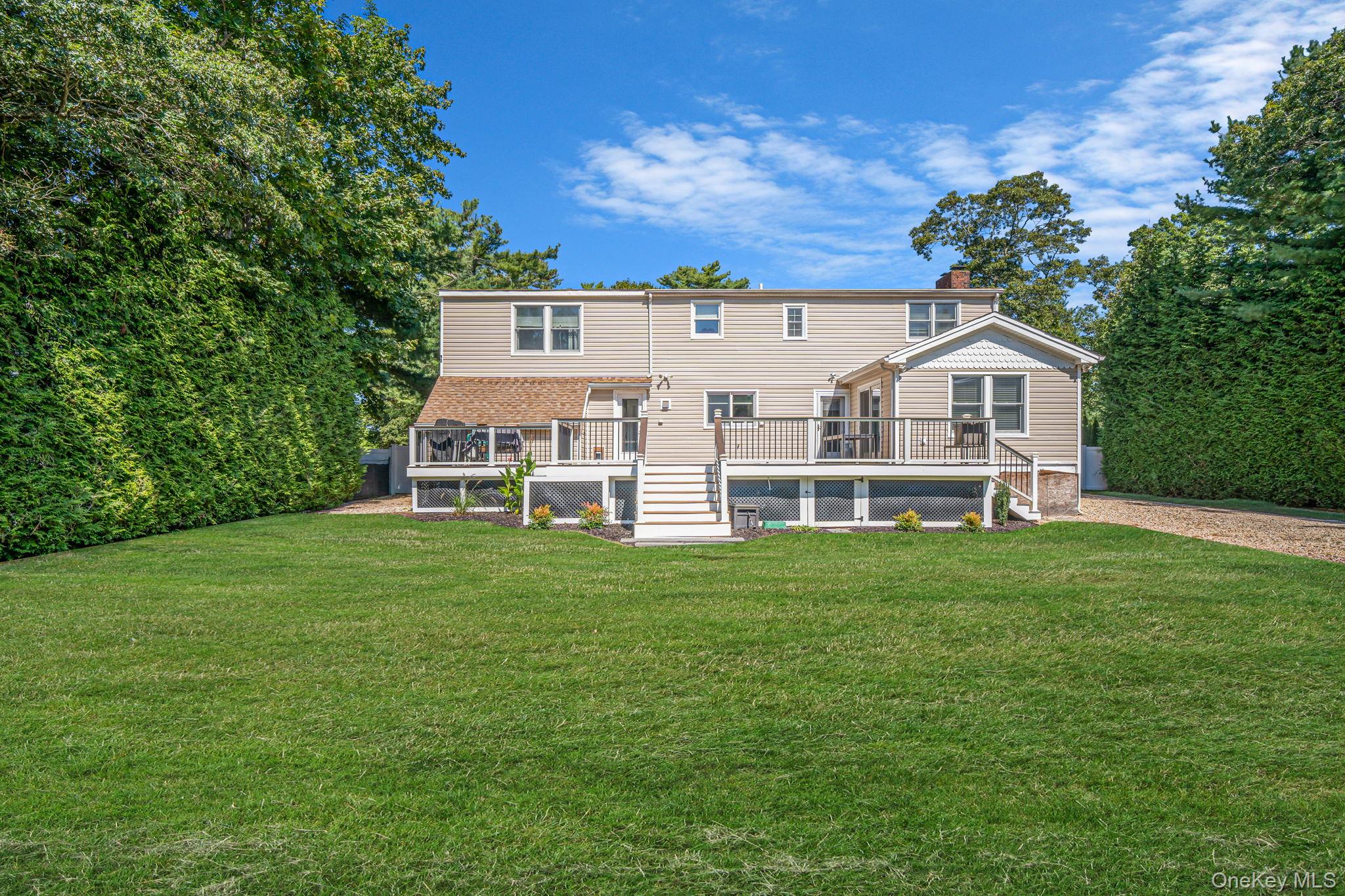 183 Old Country Road Speonk, NY 11972 - Photo 5 of 48 Rear view of property with stairway, a deck, a yard, and a chimney