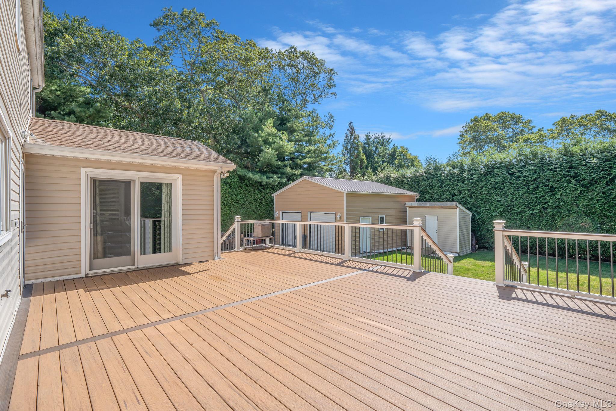 183 Old Country Road Speonk, NY 11972 - Photo 8 of 48 Deck with a shed and view of wooded area
