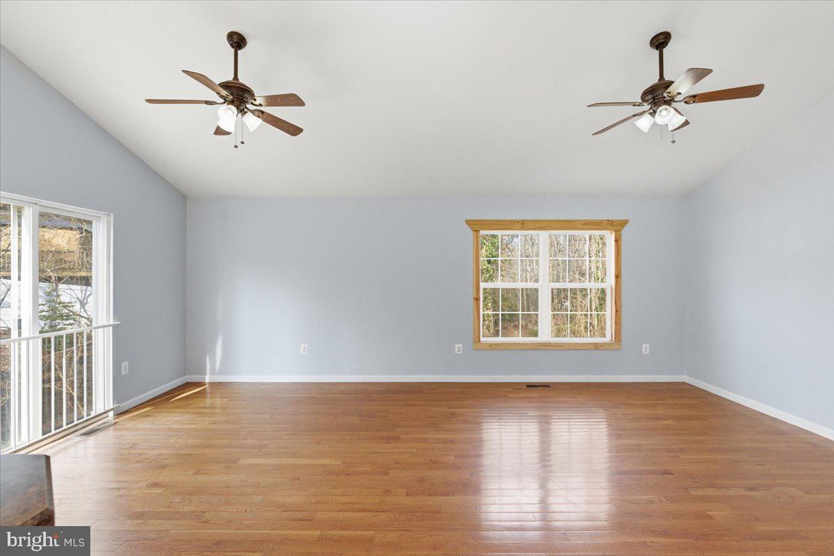 11585 Big Sandy Road Lusby, MD 20657 - Photo 15 of 48 a view of a room with wooden floor and a window