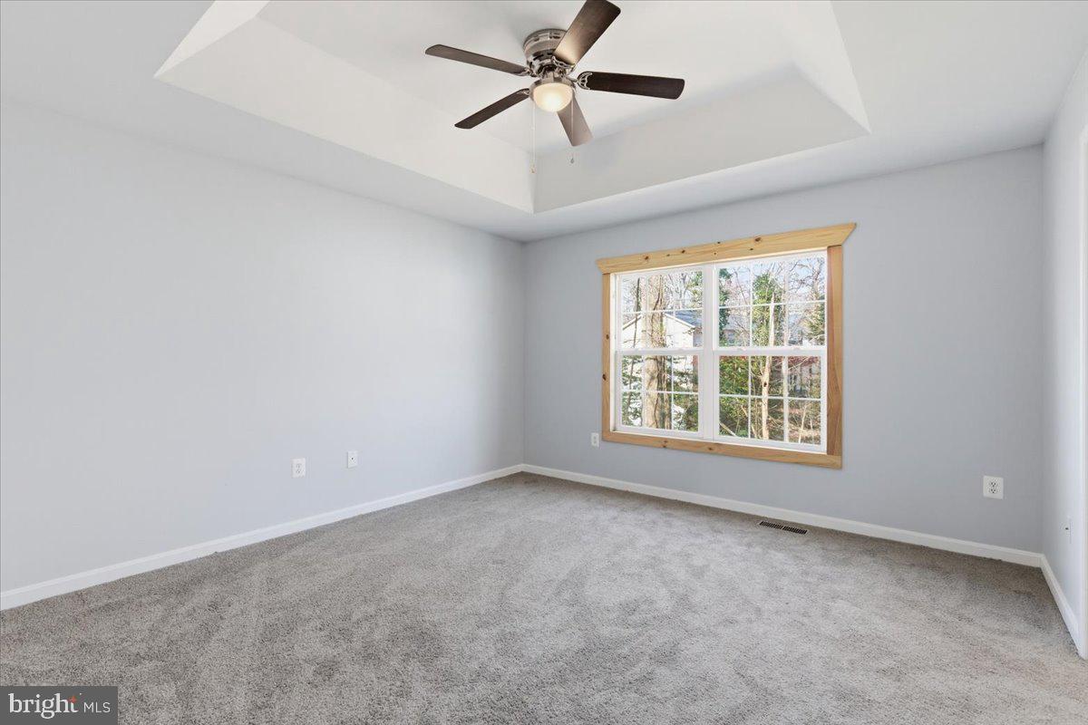 11585 Big Sandy Road Lusby, MD 20657 - Photo 18 of 48 an empty room with windows and fan