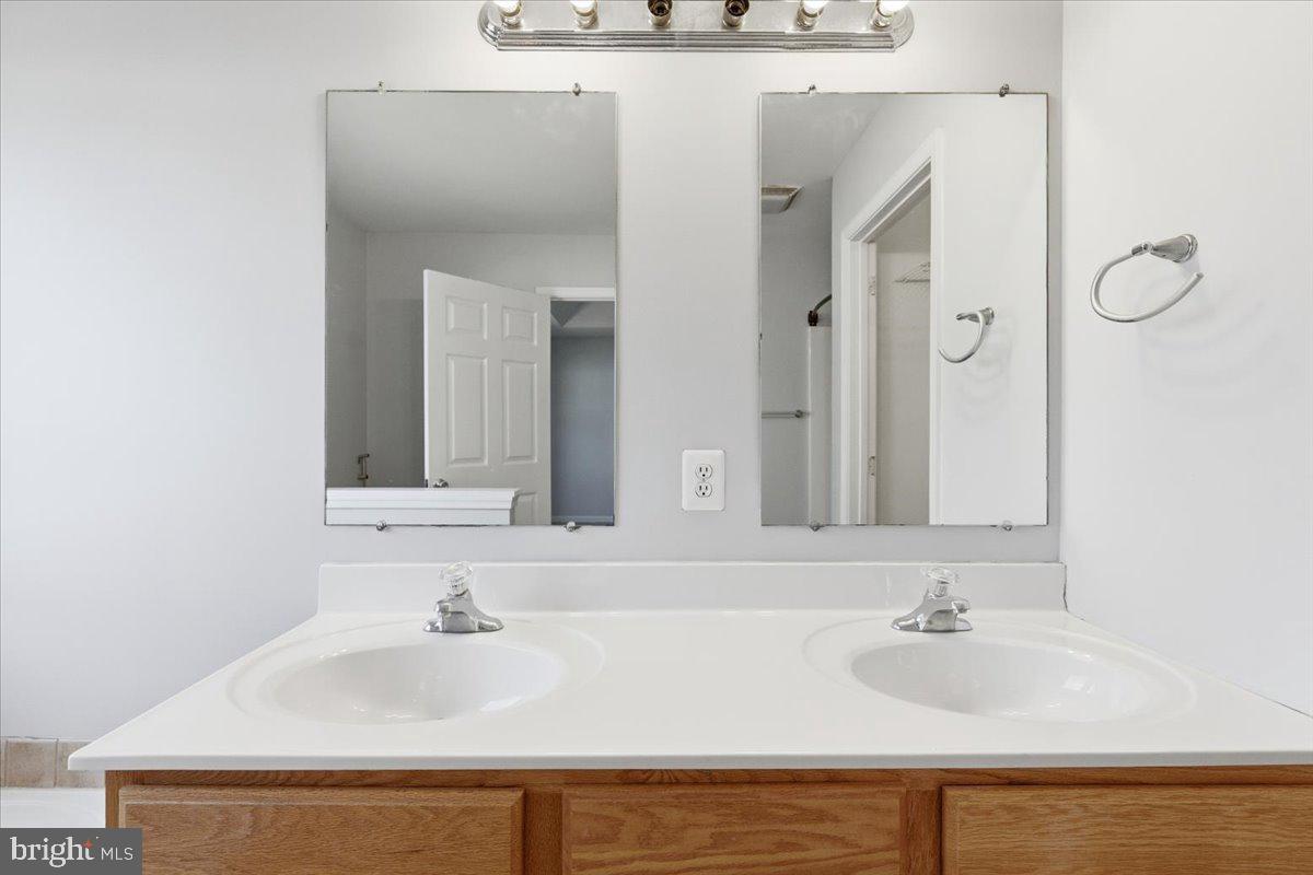 11585 Big Sandy Road Lusby, MD 20657 - Photo 22 of 48 a bathroom with a sink and a mirror
