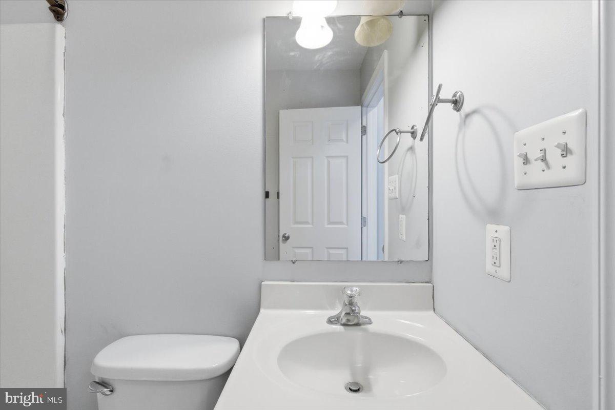 11585 Big Sandy Road Lusby, MD 20657 - Photo 26 of 48 a bathroom with a sink a toilet and a mirror