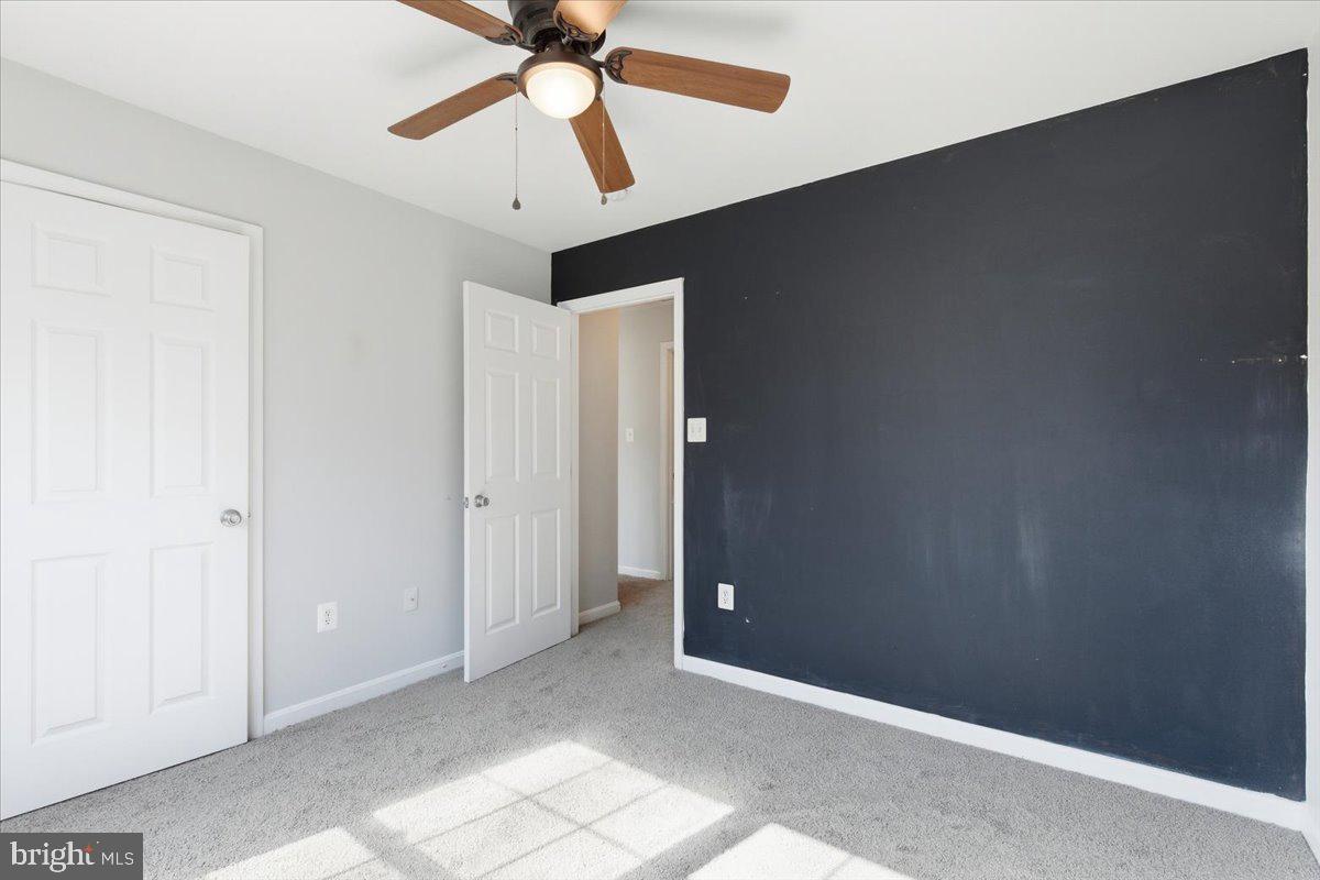 11585 Big Sandy Road Lusby, MD 20657 - Photo 30 of 48 an empty room with closet and a chandelier fan