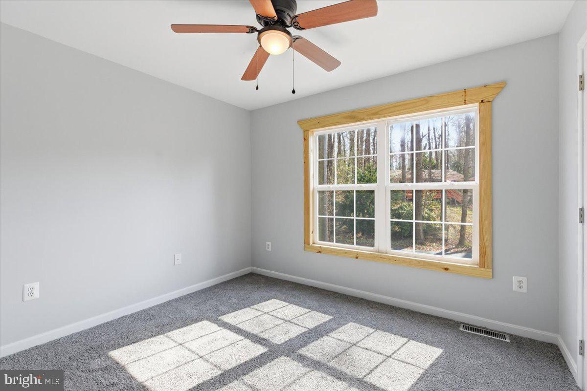 11585 Big Sandy Road Lusby, MD 20657 - Photo 31 of 48 an empty room with windows and fan