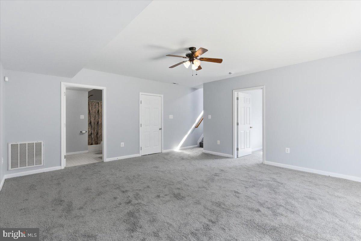 11585 Big Sandy Road Lusby, MD 20657 - Photo 35 of 48 a view of an empty room with a ceiling fan