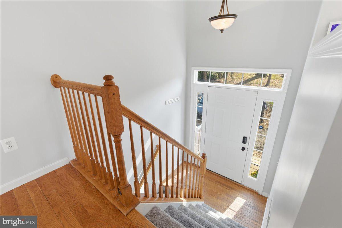 11585 Big Sandy Road Lusby, MD 20657 - Photo 6 of 48 a view of a hallway with wooden floor and staircase