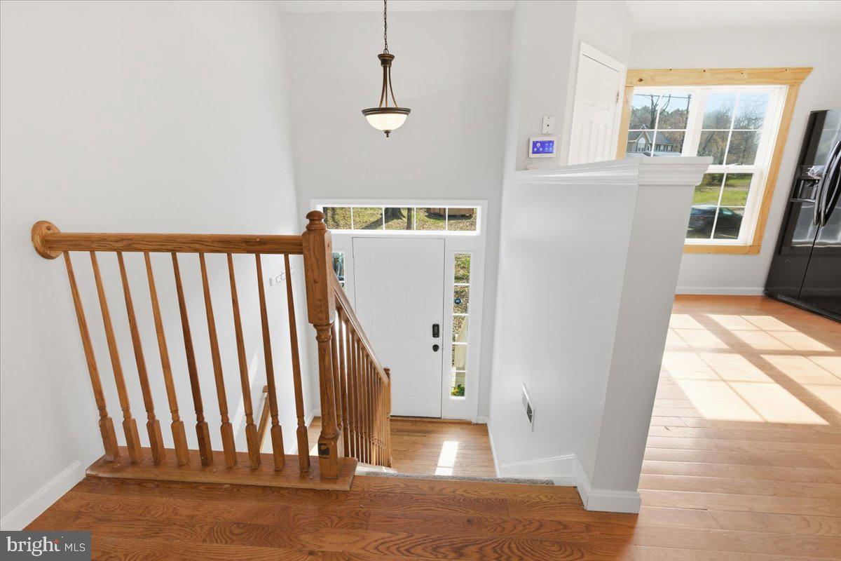 11585 Big Sandy Road Lusby, MD 20657 - Photo 7 of 48 a view of entryway with wooden floor and stairs
