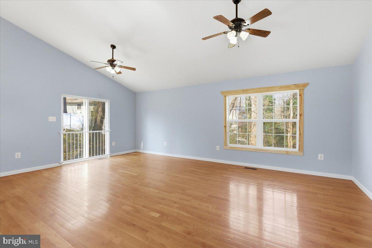 11585 Big Sandy Road Lusby, MD 20657 - Photo 8 of 48 a view of an empty room with a window and wooden floor