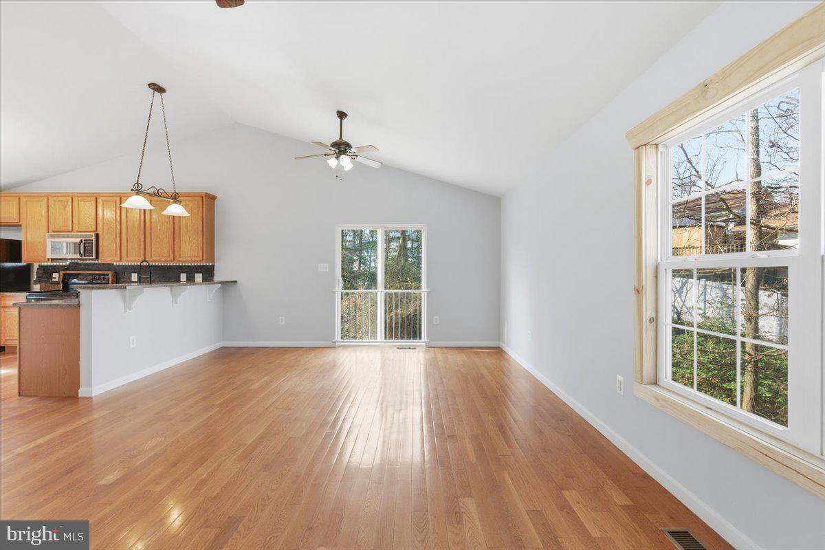 11585 Big Sandy Road Lusby, MD 20657 - Photo 9 of 48 a view of a kitchen with wooden floor and a chandelier