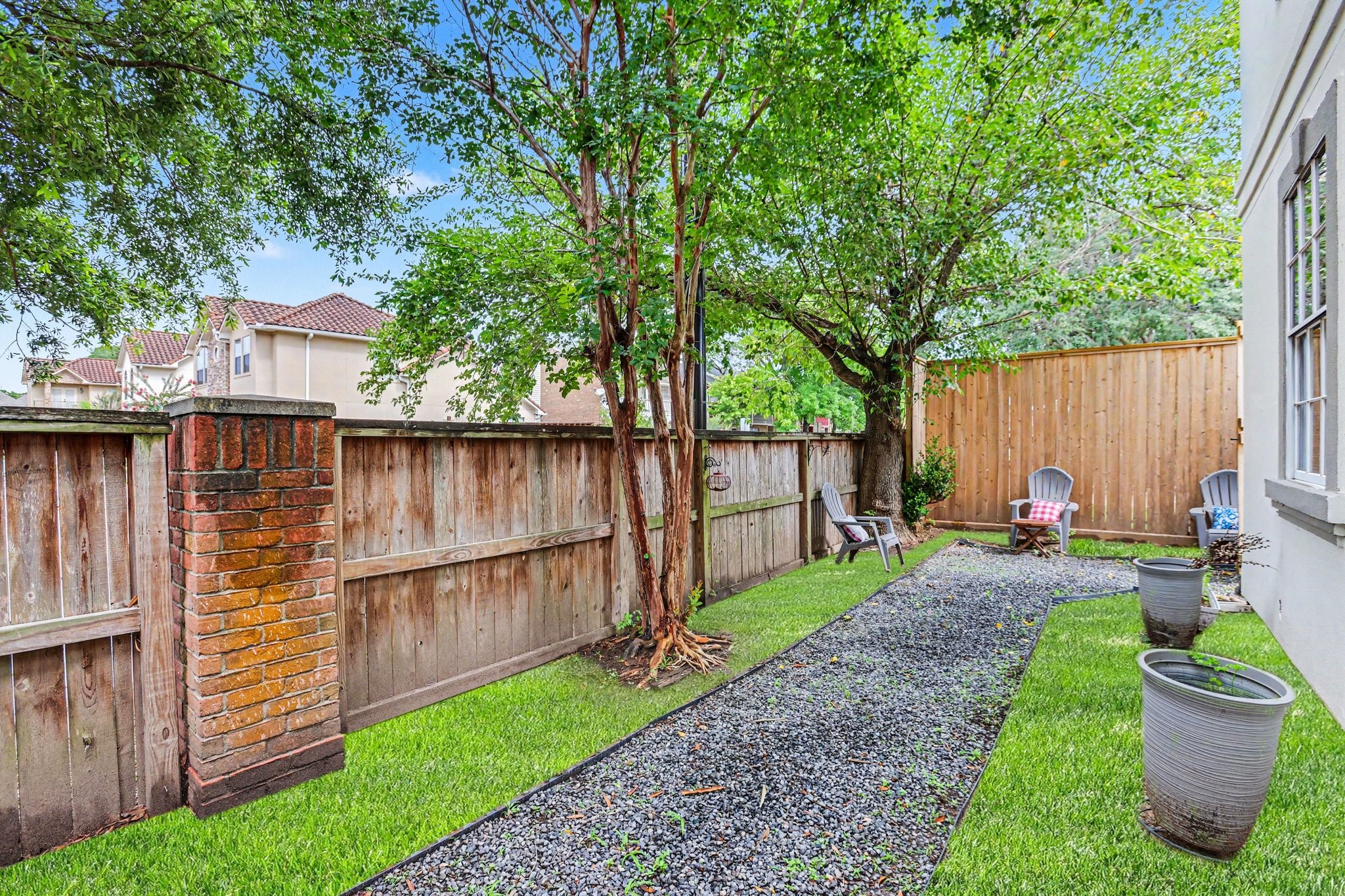 1470 Springrock Lane, Unit 6 Houston, TX 77055 - Photo 30 of 31 Side yard is part of the property and features additional fencing, creating a separate and functional outdoor space from the backyard. Virtually altered to add grass.