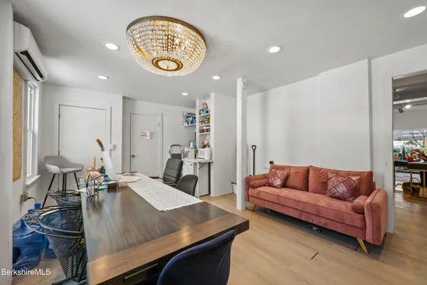 a living room with furniture and a chandelier