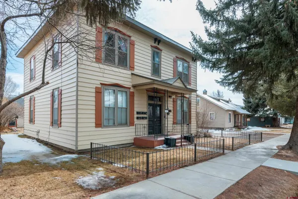 a view of a house with brick walls