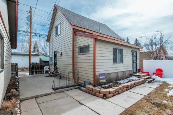 a view of a chairs and table in backyard of the house