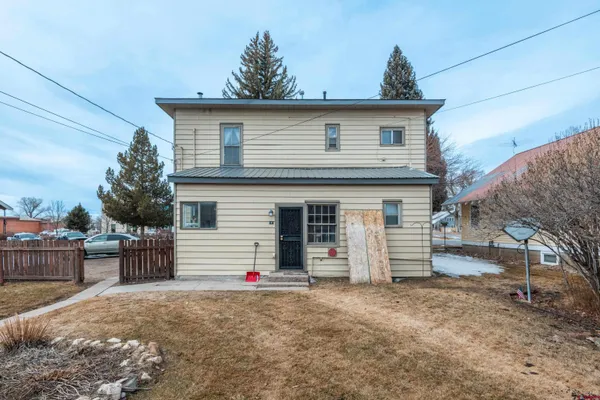 a view of a house with a yard and garage